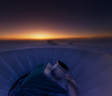 The sun sets behind BICEP2 and the South Pole Telescope.